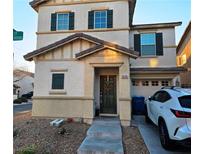 Charming two-story home featuring a well-manicured lawn and a welcoming front porch at 10265 Franford Ct, Las Vegas, NV 89183