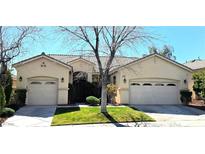 Charming single-story home with a well-manicured lawn and mature landscaping with dual garage doors at 10705 Arundel Ave, Las Vegas, NV 89135