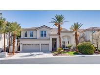 Charming two-story home featuring a well-manicured lawn, lush trees, and a three-car garage at 12 Cascade Lake St, Las Vegas, NV 89148
