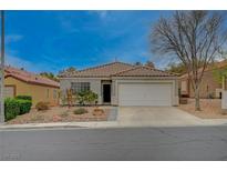 Charming single-story home featuring a well-maintained front yard and a two-car garage at 1404 Dragon Rock Dr, Henderson, NV 89052