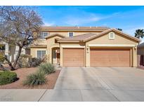 Charming two-story home boasts a well-manicured lawn and a convenient two-car garage at 1831 Cavendish Way, Henderson, NV 89012