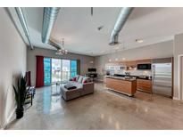 Open-concept living room features modern design elements, city views, and a spacious layout perfect for entertaining at 200 Hoover Ave # 1210, Las Vegas, NV 89101