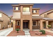 Charming two-story home featuring a well-kept yard and inviting front porch with a comfortable bench at 2199 Timescape Ct, Las Vegas, NV 89123