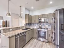 Modern kitchen with stainless steel appliances and granite countertops offers style and functionality at 251 S Green Valley Pkwy # 3412, Henderson, NV 89012
