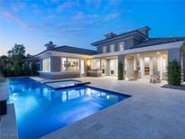 Inviting backyard oasis with a sparkling pool, spa, and covered patio perfect for outdoor relaxation at 2623 Turtle Head Peak Dr, Las Vegas, NV 89135
