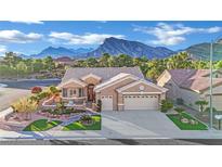 Charming single-story home featuring a three-car garage and manicured front yard with mountain views at 2813 Vista Butte Dr, Las Vegas, NV 89134