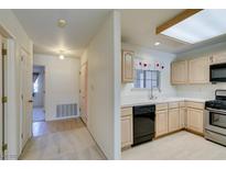 Bright kitchen featuring light wood cabinetry, modern appliances, and a window for natural light at 2851 S Valley View Blvd # 1161, Las Vegas, NV 89102