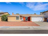 Single-story home with a two-car garage and a low-maintenance front yard at 3610 El Camino Rd, Las Vegas, NV 89103