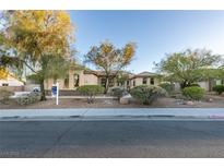 Charming single-story home with landscaped front yard featuring mature trees and desert landscaping at 3801 W Hammer Ln, North Las Vegas, NV 89031