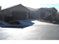 Charming single-story home with a neutral color scheme, arched entryway, and desert landscaping at 4242 Helena Hideaway Ct, Las Vegas, NV 89129