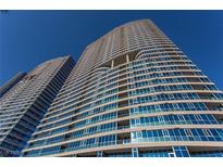 Stunning high-rise building featuring modern architecture with reflective glass windows against a vibrant blue sky at 4575 Dean Martin Dr # 3007, Las Vegas, NV 89103