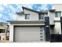 Modern two-story home with gray accents, a two-car garage, and contemporary architectural details at 483 Fairview Hills St, Las Vegas, NV 89138