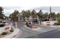 View of the gated entrance to the Las Casitas community with mature trees at 4866 Nara Vista Way # 202, Las Vegas, NV 89103