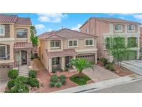 Charming two-story home featuring a tile roof, desert landscaping, and an inviting front porch at 6435 Parrot Ridge Ct, Las Vegas, NV 89139