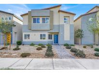 Charming two-story home with modern design, rock landscaping, and a welcoming blue front door at 7476 Moonglade St, North Las Vegas, NV 89084