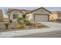 Charming single-story home with a well-maintained xeriscaped front yard and a two-car garage at 7567 Wingspread St, North Las Vegas, NV 89084