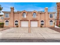 Charming townhome featuring a two-car garage and well-maintained front yard at 8400 Majestic View Ave, Las Vegas, NV 89129
