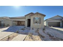 Charming single-story home showcasing desert landscaping and an attached two-car garage at 9067 Mapledale Ranch Ct, Las Vegas, NV 89139