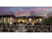 Beautiful exterior of home with desert landscaping and lighted walkway at 20 Pebble Hills Ct, Las Vegas, NV 89141