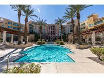 Resort-style swimming pool with palm trees and manicured landscaping enhancing the upscale condo community at 30 Strada Di Villaggio # 521, Henderson, NV 89011