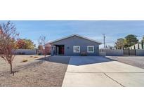 Charming home with a long concrete driveway, desert landscaping and grey brick perimeter wall at 3675 W Maule Ave, Las Vegas, NV 89118