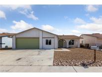 Charming single-story home featuring stucco siding, a green garage door, and desert landscaping at 3756 Lone Oak St, Las Vegas, NV 89115