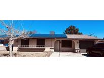 Charming single-story home with solar panels, neutral paint, a well-kept front yard, and an attached garage at 4360 Wendy Ln, Las Vegas, NV 89115