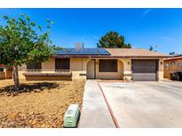 Charming single-story home featuring solar panels, a well-maintained yard, and a convenient attached garage at 4360 Wendy Ln, Las Vegas, NV 89115