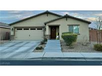 Charming single-story home featuring a two-car garage and a welcoming front entrance with a beautiful wreath at 4533 Morton Grove Ave, Las Vegas, NV 89115