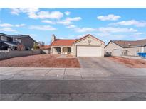 Charming single-story home with a red tile roof, two-car garage, and low maintenance rock yard at 5762 Shinyleaf Cir, Las Vegas, NV 89142