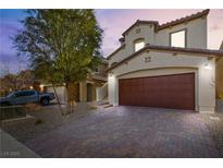Inviting two-story home featuring a brick driveway and an attached two-car garage at 826 N Water St, Henderson, NV 89011