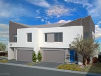 Modern two-story home featuring a clean white facade, gray accents, and well-manicured landscaping at 8629 Ensworth St # 112, Las Vegas, NV 89123