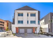 Modern two-story townhome showcasing a neutral color scheme, multiple windows, and an attached two-car garage at 8629 Ensworth St # 114, Las Vegas, NV 89123