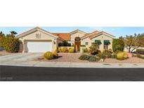 Charming single-story home with a terracotta tile roof, desert landscaping and a two-car garage at 10548 Findlay Ave, Las Vegas, NV 89134
