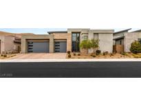 Contemporary home boasts a two-car garage, neutral color scheme, and professionally landscaped front yard at 10794 White Clay Dr, Las Vegas, NV 89135