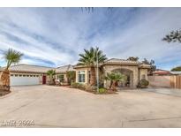Beautiful single-story home featuring desert landscaping, a horseshoe driveway, and a gated side entrance at 1331 S Monte Cristo Way, Las Vegas, NV 89117