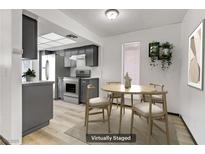 Bright kitchen features stainless steel appliances, modern cabinetry, and an adjacent dining area with stylish furnishings at 1390 Vegas Valley Dr # 32, Las Vegas, NV 89169
