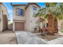 Charming two-story home with neutral stucco exterior, attached garage and desert landscaping at 2112 Pillar Pointe St, Las Vegas, NV 89115