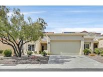 Charming single-story home featuring a well-maintained front yard and an attached two-car garage at 2301 Hallston St, Las Vegas, NV 89134