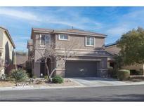 Two-story home featuring a two-car garage and low maintenance landscaping at 2437 Rue Royale St, Henderson, NV 89044