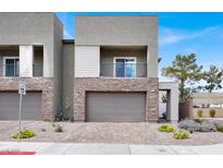 Beautiful townhome with a two-car garage, stone accents, balcony and modern architectural style at 315 Owens Peak Dr, Henderson, NV 89015