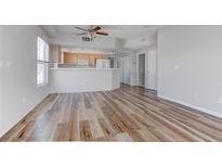Bright, open-concept living room featuring wood-look flooring and natural light, complemented by neutral walls at 3604 Lisandro St # 204, Las Vegas, NV 89108