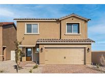Two-story home featuring a neutral exterior, paver driveway, and a two-car attached garage at 4244 Golden Sol St, North Las Vegas, NV 89032