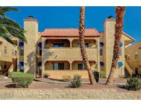 Two-story condo building showcasing unique architectural details, landscaping, and a red tile roof at 4704 Obannon Dr # B, Las Vegas, NV 89102