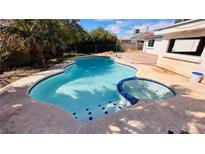 Inviting pool with attached hot tub, tiled trim, and a patio area, perfect for relaxation and backyard entertainment at 5279 Consul Ave, Las Vegas, NV 89142