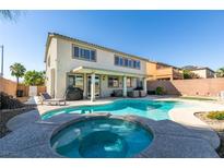 Inviting backyard pool and spa with outdoor lounge area is perfect for entertaining and relaxing at 6220 Silver Edge St, North Las Vegas, NV 89031