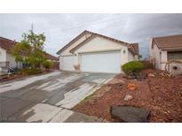 Charming single-story home with three-car garage and a well-manicured front yard at 6510 Evening Rain Ave, Las Vegas, NV 89156