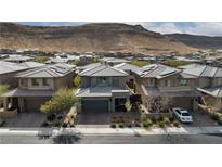 Beautiful two-story home featuring desert landscaping, brick driveway, and mountain views at 7023 Amethyst Peak St, Las Vegas, NV 89148