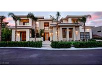 Contemporary two-story home with a landscaped yard, elegant design, and desert landscaping at 7430 Yonie Ct, Las Vegas, NV 89117
