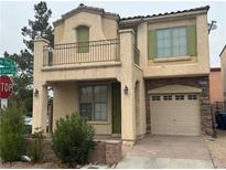 Charming two-story home features a balcony, stone accents, and a two-car garage at 9592 Villa Calera Ave, Las Vegas, NV 89148